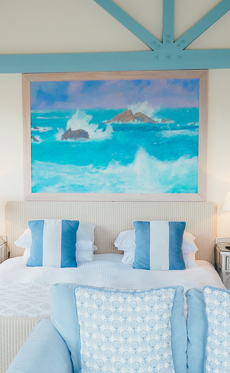 Beach-themed bedroom with two custom printed cotton canvas pillows on the bed